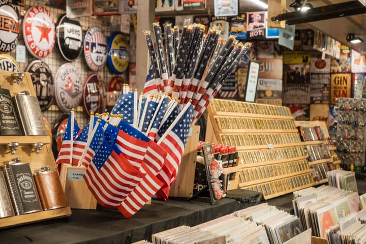 Shop interior with patriotic American flags and souvenirs displayed.