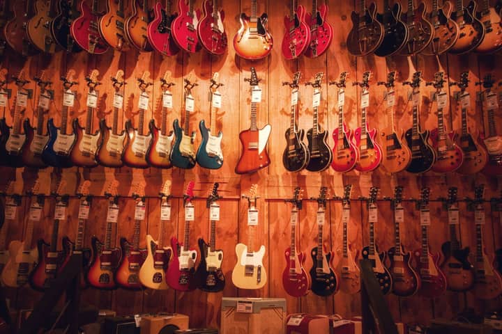 Vibrant display of various electric guitars hanging in a Los Angeles music store.