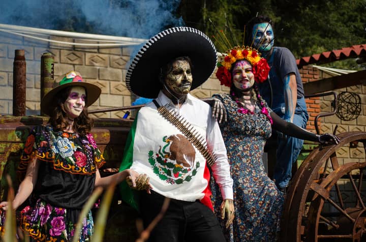 Vibrant portrayal of Dia de los Muertos, featuring traditional costumes and face paint in Mexico City.