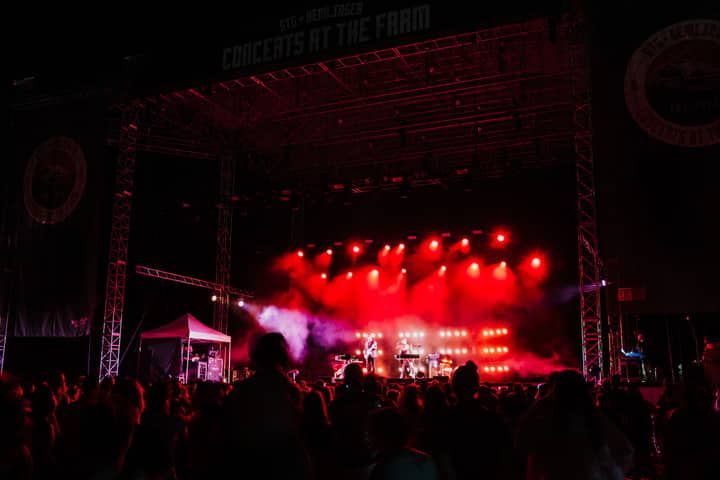 Energetic concert night at Seattle's iconic outdoor venue. Captivating music, lively crowd under bright stage lights.