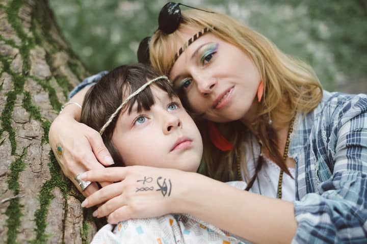 Close-up of a mother and child embracing lovingly outdoors, conveying warmth and connection.