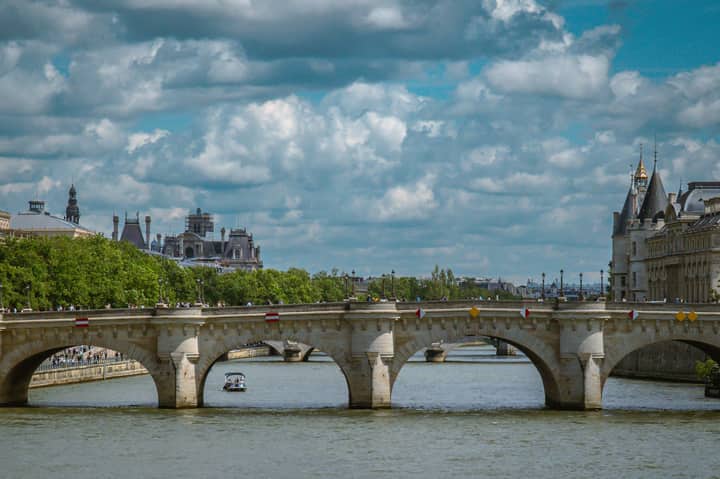 Scenic view of Pont Neuf and the Seine River in Paris, showcasing historic architecture.