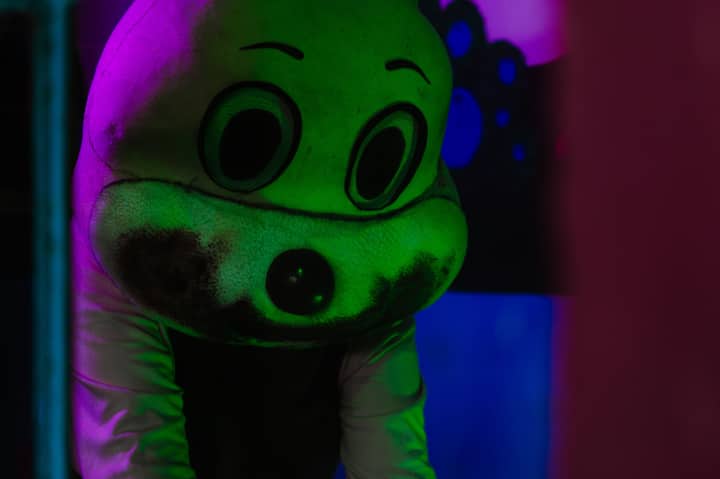 A spooky figure in a costume with dramatic lighting, creating a Halloween atmosphere.