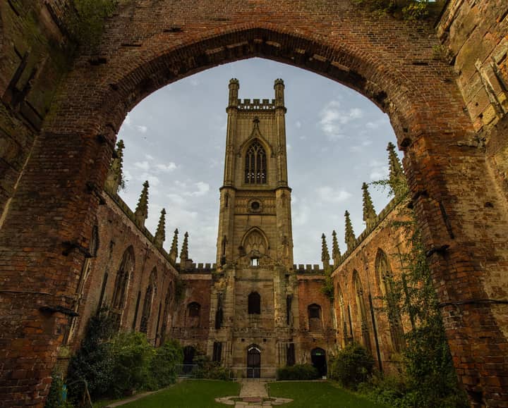 Historic ruins of St Luke's Church with arched entrance and Gothic architecture in Liverpool.