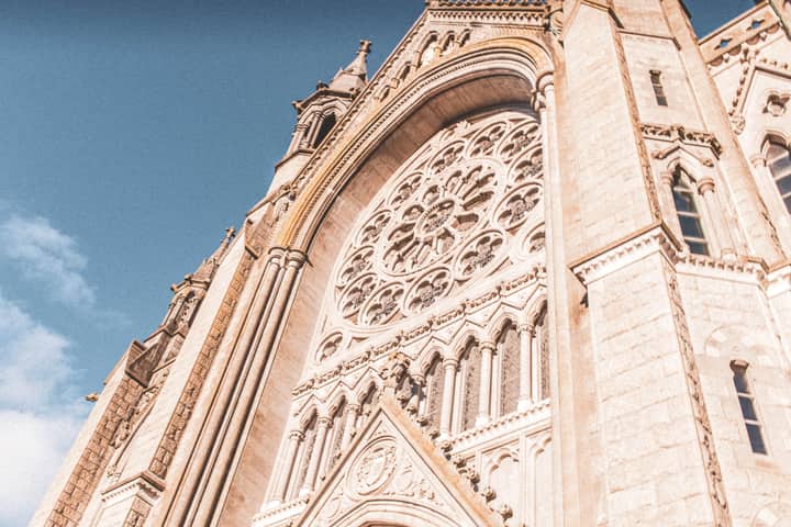 Close-up of St. Colman's Cathedral showcasing intricate gothic stonework in Cobh, Ireland.