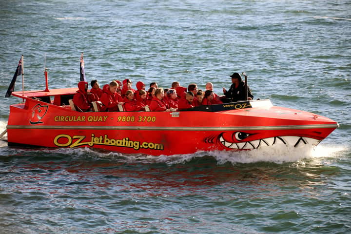 Tourists enjoy a thrilling jet boat ride on Sydney Harbour with iconic views of Circular Quay.