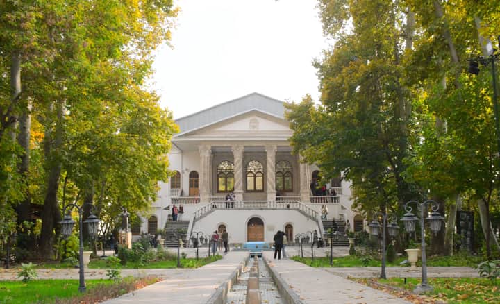 Elegant Iranian architecture amidst vibrant gardens in Tehran, Iran.