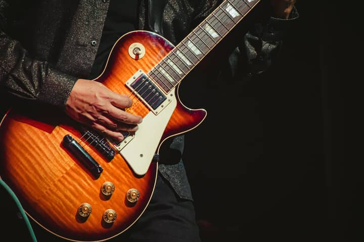 Detailed close-up of guitarist playing a Les Paul at a live concert in Tlaxcala, México.