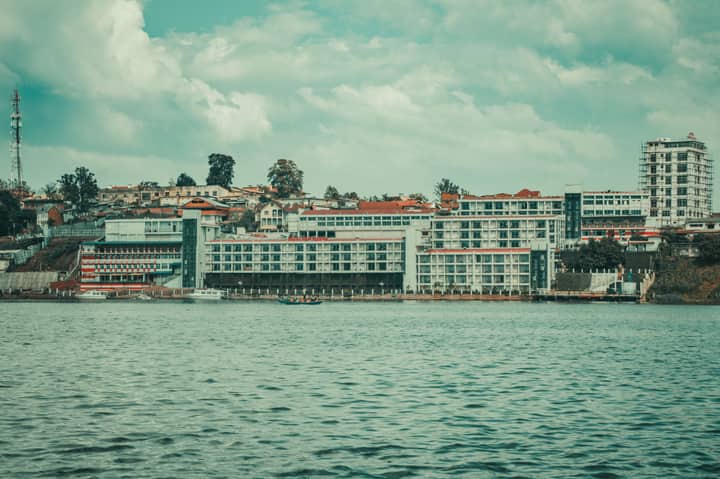 Tranquil view of the Bukavu waterfront with modern architecture and lake in Sud-Kivu, DRC.