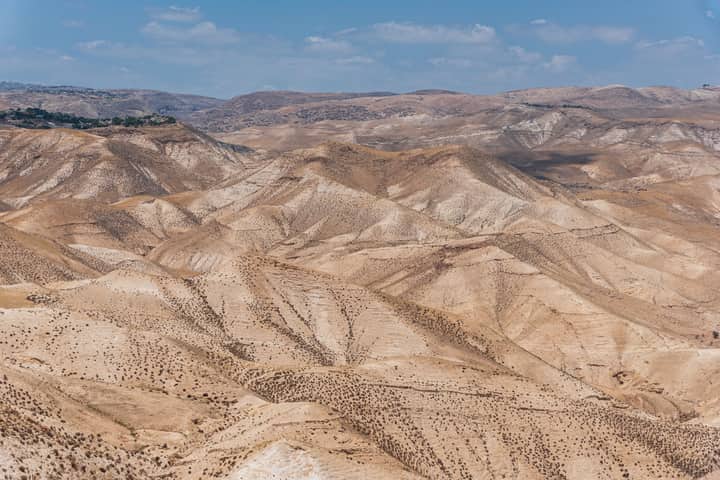 Scenic view of arid desert hills under a clear blue sky in Israel.