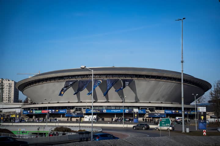 Spodek Arena in Katowice featuring a vibrant esports event atmosphere with banners.