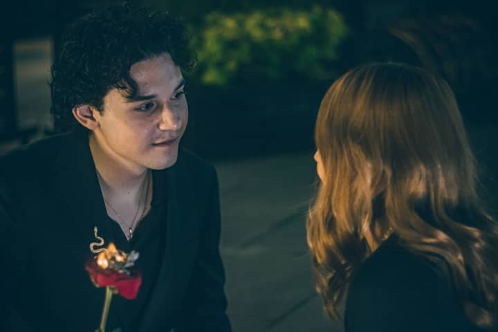 A couple shares a tender moment outdoors at night in Mexico City.