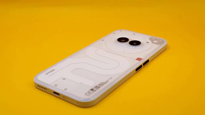 A modern smartphone with dual cameras on a vivid yellow background. Minimalist tech vibe.