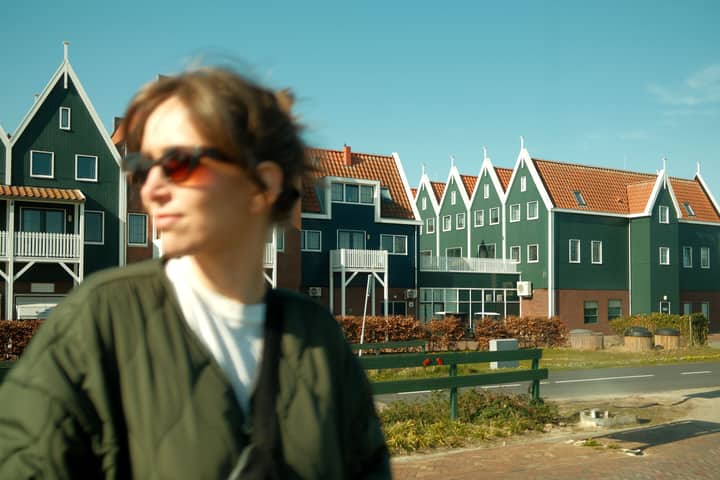 Blurred person with Dutch-style houses in Volendam, Netherlands.