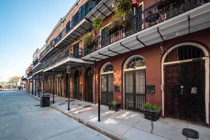 Iconic ironwork balconies of a historic New Orleans street in the French Quarter.