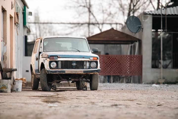 A vintage Lada Niva parked in a rural setting in Salyan, Azerbaijan.