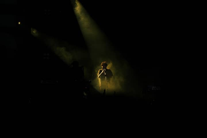 Captivating concert scene featuring a flute player under dramatic stage lighting.