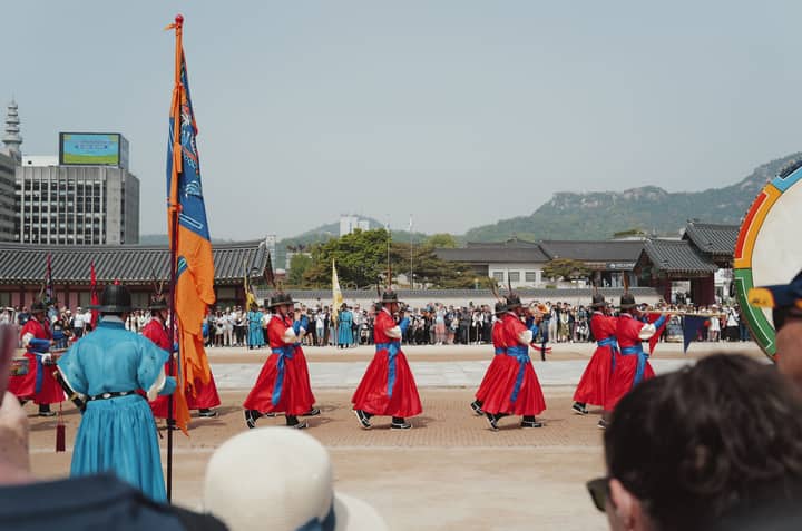 Vibrant traditional guard ceremony at a palace in Seoul, South Korea, showcasing cultural heritage.