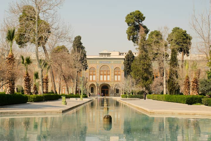Explore Tehran's iconic Golestan Palace featuring a stunning reflection pool and Persian architecture.