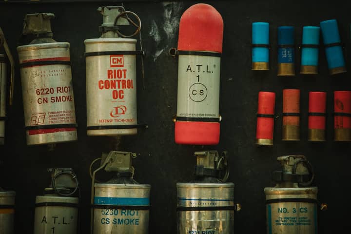 Close-up image of various riot control devices used in military settings.