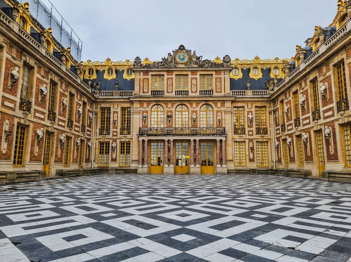 Experience the grandeur and intricate architectural design of the Palace of Versailles courtyard, a hallmark of French history.
