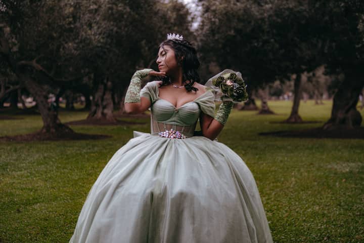 Charming quinceañera in elegant gown posing in San Isidro park, Lima, Peru.