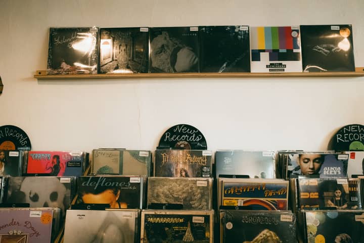 Vintage vinyl records neatly displayed in a cozy indoor record shop, ideal for music enthusiasts.