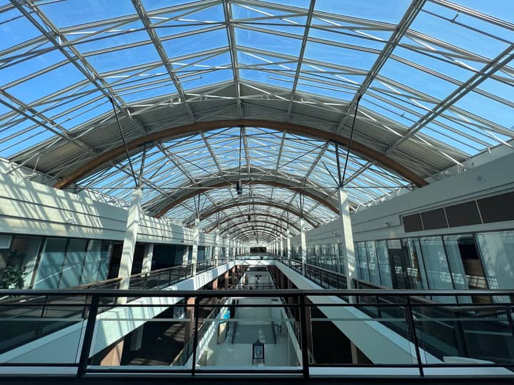 Spacious atrium with glass ceiling in Portland, Oregon, showcasing modern architecture and natural light.