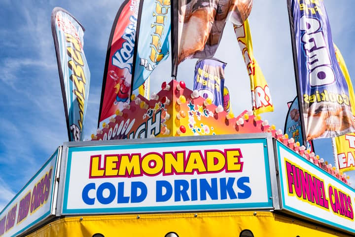 Vibrant carnival stand with lemonade and cold drinks in West Springfield.
