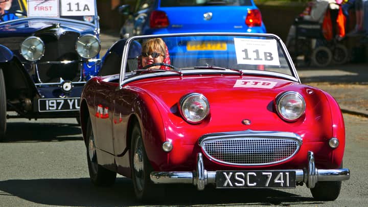 Vintage red Austin Healey on display at a car show in Lytham St Annes, England. Bright sunny day.