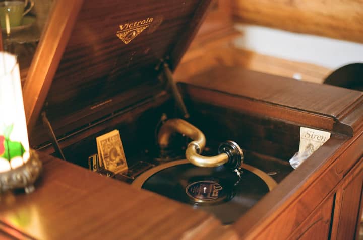A charming vintage Victrola record player with an elegant wooden finish adds classic warmth to the room.