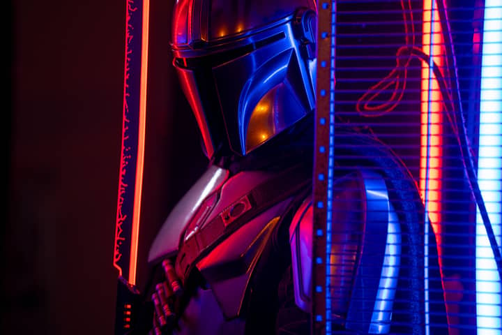 Mandalorian cosplay with vibrant neon lights in a dark studio setting in Stockholm, Sweden.