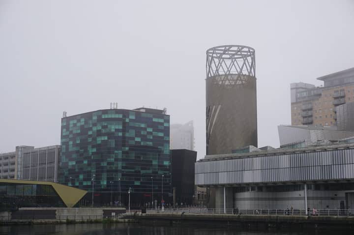 A foggy morning view of modern architecture in Salford, United Kingdom.
