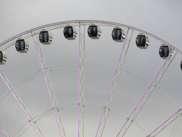 Close-up view of the Seattle Great Wheel's gondolas on a cloudy day.