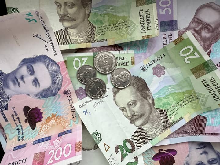 Detailed image of Ukrainian hryvnia banknotes and coins displaying design and denomination.
