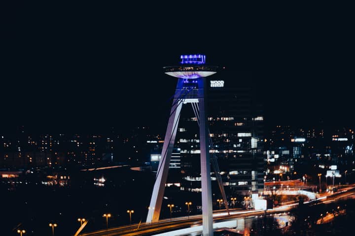 Stunning night view of the UFO Observation Deck in Bratislava, Slovakia, showcasing the city's vibrant skyline.