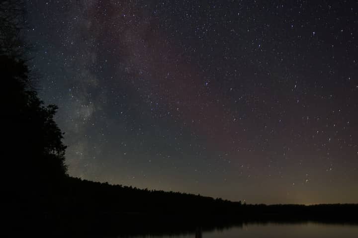 Stunning view of the Milky Way over Stechlin Lake in Brandenburg, Germany, showcasing a clear starry night sky.