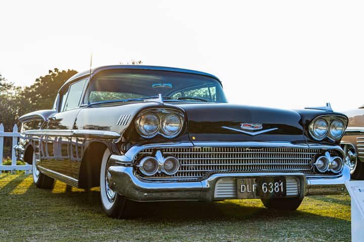 Classic 1958 Chevrolet Bel Air displayed at an outdoor car show in Gurugram, India.