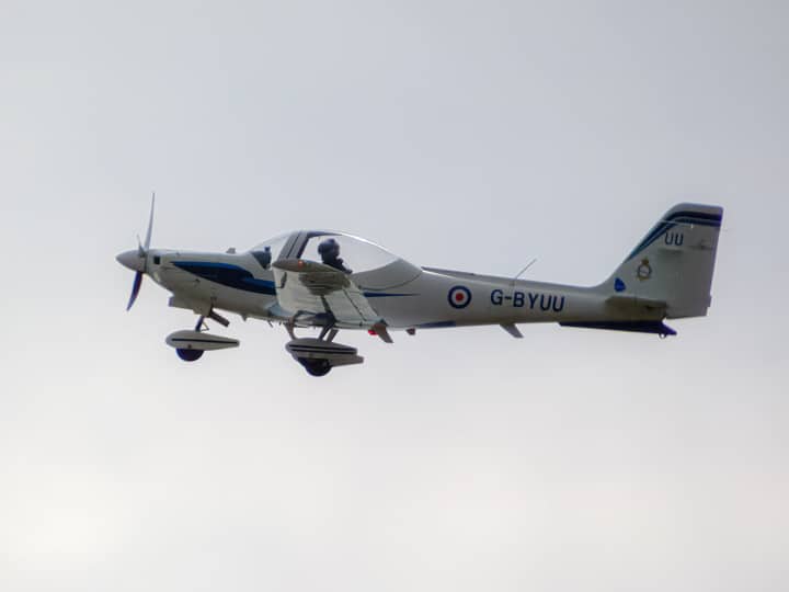 A light aircraft flying in a clear sky, showcasing aviation technology and design.