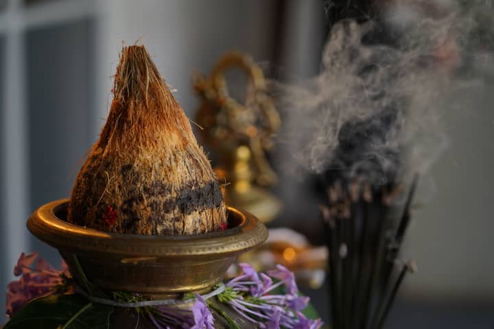 Close-up of a Pongal pot with coconut and incense, Sri Lanka.