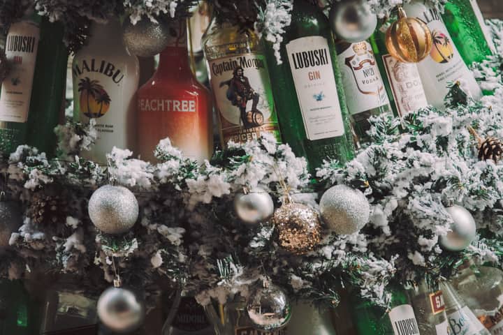 Holiday-themed display with various bottles and festive ornaments, perfect for winter celebrations.
