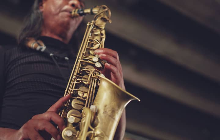 Close-up of a jazz musician performing with a saxophone, showcasing musical artistry.