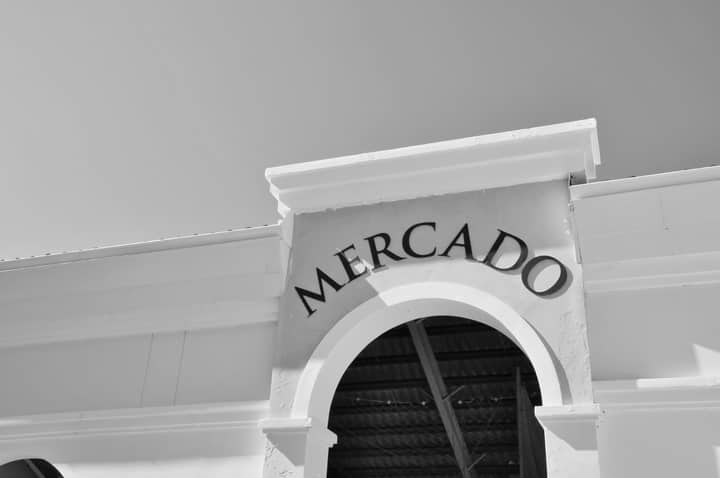 A black and white image of a mercado entrance with arch detail in the Dominican Republic.