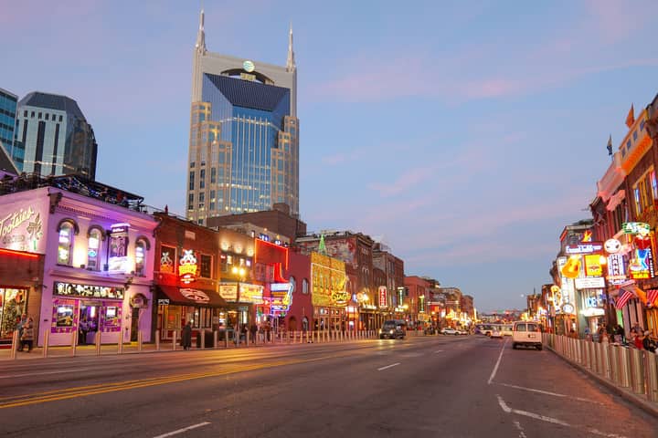 Explore the lively streets of Nashville, Tennessee with bright neon signs and iconic architecture.