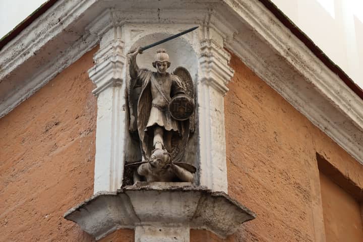 A detailed view of the Saint Michael statue on a historic corner in Cádiz, Andalucía, Spain.