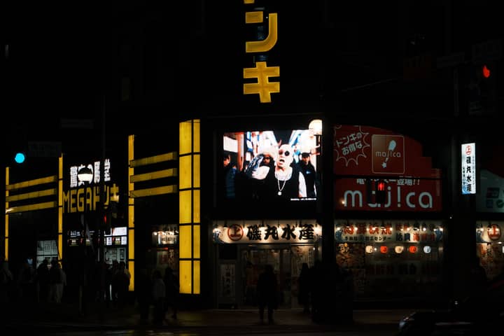 Neon-lit street scene at night in Sapporo, Japan, showcasing the vibrant city nightlife.