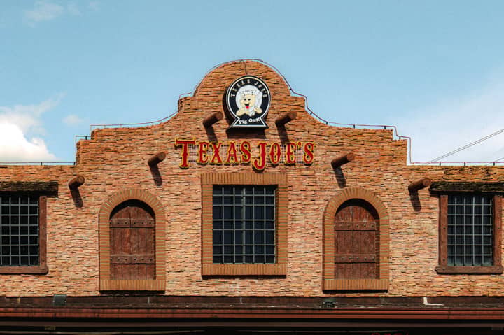 Facade of Texas Joe's BBQ restaurant with rustic brickwork and logo.