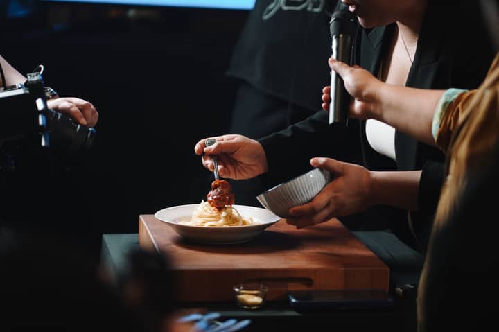 Close-up of a food photography session featuring spaghetti and meatballs.