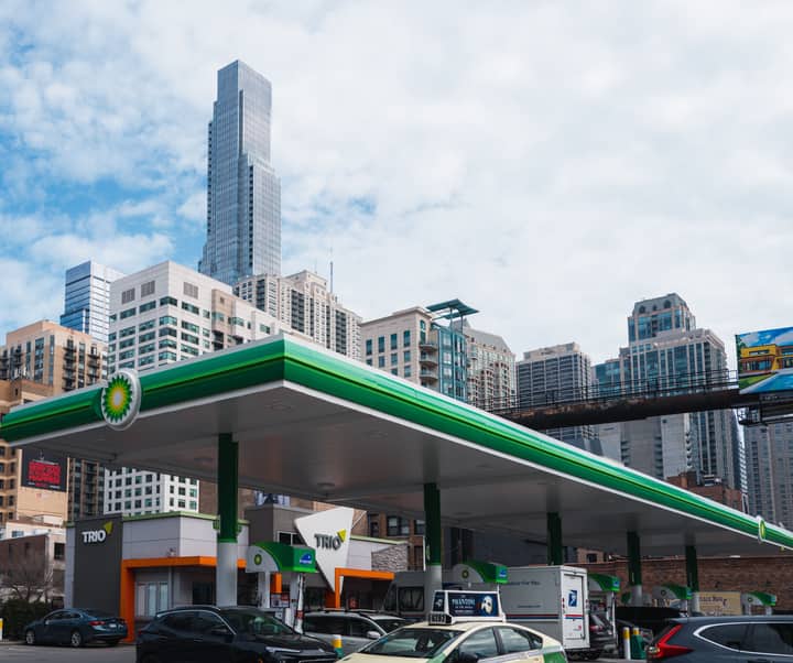 A modern Chicago skyline above a busy urban gas station, capturing city life.