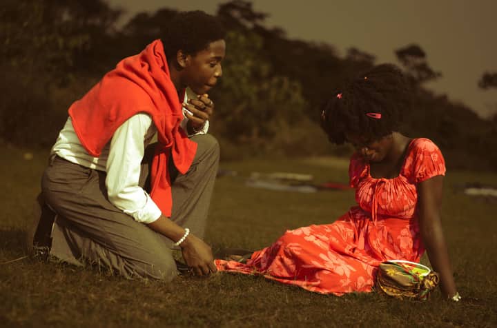 A young couple enjoying a warm day outdoors in Gaga, Nigeria. Relaxed and joyous setting.